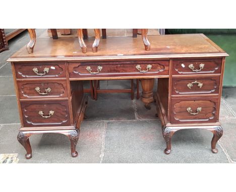 An Edwardian mahogany desk with tooled leather writing surface, the locks marked 'RC&amp;S' with a crown.  
