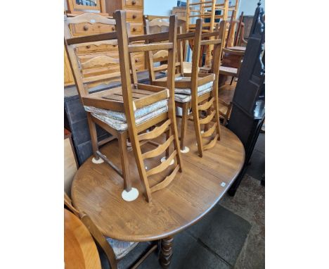 An Ercol elm extending dining table and six chairs. Dimensions (approx)- height 74.5cm, length 160.5cm extending to 211cm and