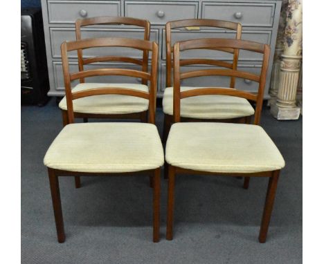 A set of four E-gomme G-Plan dining chairs designed by Victor Wilkins, 1960s, with rail ladder back rest, and cream padded se