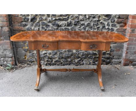 An Edwardian style string inlaid mahogany sofa table, in the Regency style, with matchbook flame veneer top above three drawe