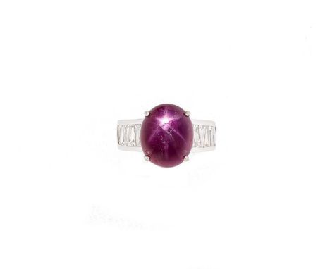 A Burmese star ruby and diamond ring, claw set oval cabochon star ruby, 15.99 x 13.25 x 6.74mm, shoulders set with tapered ba