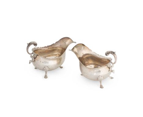 2 Edward VII silver sauce boats, mark of Marston &amp; Bayliss, Birmingham 1901, each with cut rim and leaf capped flying scr