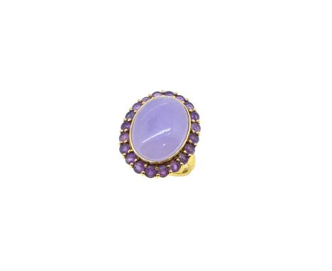 A jade and amethyst cluster ring, oval cabochon jade (untested for treatments), approximately 19 x 14mm, surrounded by twenty