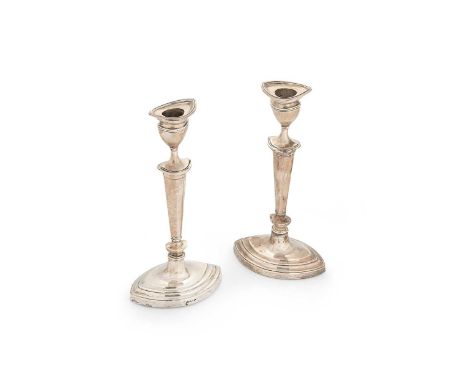 A pair of Edward VII silver library candlesticks, mark of Williams (Birmingham) Ltd., Birmingham 1907, each loaded base of st