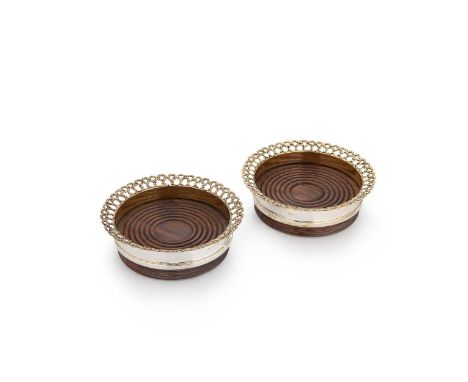 A pair of Elizabeth II parcel gilt bottle coasters, mark of Stuart Devlin, London 1976, each with ribbed side and flared and 