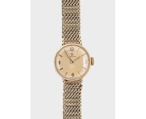 Omega - A 9ct gold wristwatch, circa 1962, model 711.5500, serial number 19932581, circular champagne dial with gold coloured