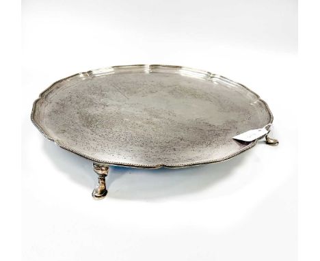 A George V silver salver,  mark of Hawksworth, Eyre & Company Ltd., London 1922, 'Chippendale' style with beaded rim, raised 