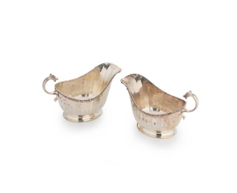 A pair of George VI silver sauce boats, mark of Rattray &amp; Company, Birmingham 1940, each with panelled side, Celtic rim a