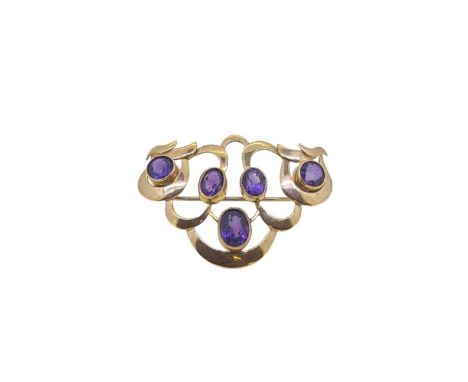 An amethyst brooch, set with three oval faceted amethysts and two round faceted amethysts, dimensions 5 x 3.8cm, pin and roll