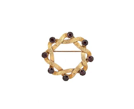 A garnet wreath style brooch, eight claw set round faceted garnets, textured finish, diameter 3.8cm, pin and roller catch fit