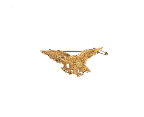 A continental diamond set eagle brooch, the flying eagle set with a round brilliant cut diamond for an eye and another suspen