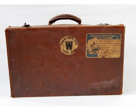 Vintage leather suitcase bearing 'Cunard White Star Cabin Club' label (with loss) and 'Cunard White Star to Europe' label 