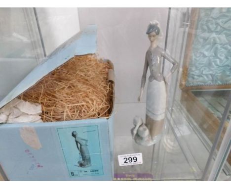A boxed Lladro figure with geese