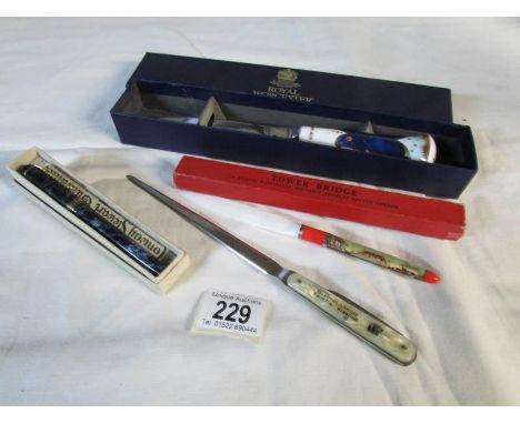 A Royal Worcester paper knife, a Tower of London paper knife, an advertising paper knife incorporating pen knife and a founta