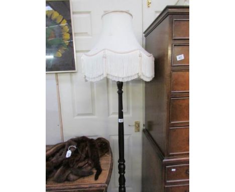 A standard lamp with shade
