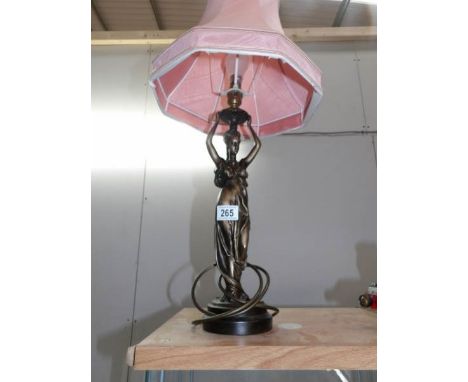 A figural table lamp with shade