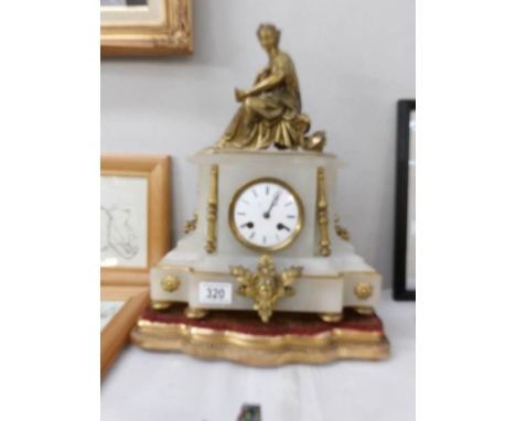 A gilt and marble clock surmounted figure