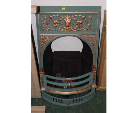 Green and gilt painted cast iron fire surround with grate 