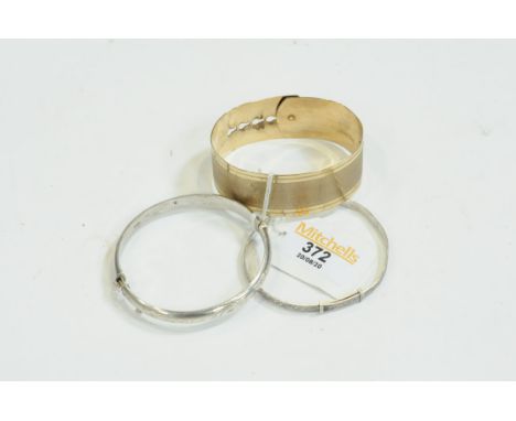 Yellow metal bangle and 2 silver bangles 