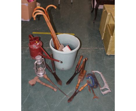 Large watering can, tools, slash clamps, axe, saw, storm lamp etc