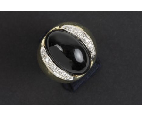 nineties' ring in yellow gold (18 carat) with a cabochon of black onyx and ca 0,50 carat of high quality brilliant cut diamon