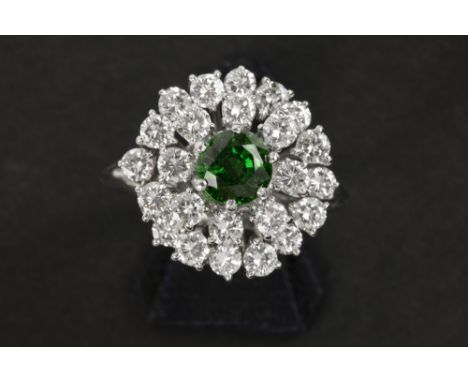 classy ring with a cocktail design in white gold (18 carat) with a 1,07 carat Tsavarite surrounded by ca 1,90 carat of very h