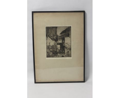 A FRAMED AND GLAZED PENCIL SIGNED ETCHING DEPICTING A STREET SCENE