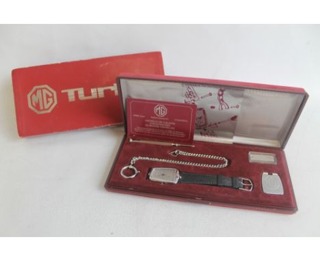 A BOXED SWISS MADE MG TURBO QUARTZ WRIST WATCH in the shape of a vintage MG grille on original leather strap with guarantee d
