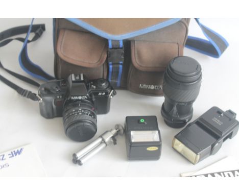 A MINOLTA XG9 CAMERA with Sigma master zoom and Sigma 70 - 210 mm VC zoom + flashes, tripod etc in Minolta carry bag