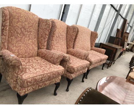 A WING BACK TWO SEATER SOFA ON MAHOGANY CABRIOLE SUPPORTS AND TWO MATCHING ARMCHAIRS 