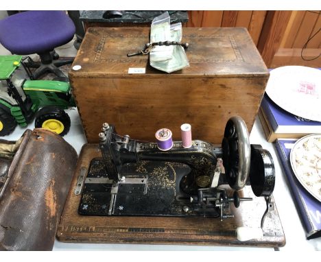 A VINTAGE CASED 'FRISTER &amp; ROSSMANN' SEWING MACHINE WITH ORIGINAL MANUAL 