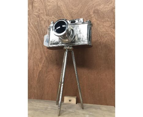 A VINTAGE CHROME CAMERA ON A STAND 