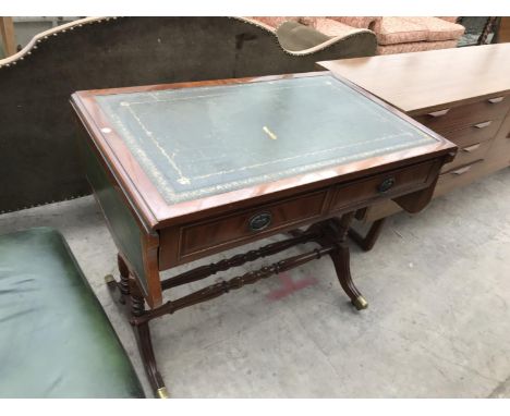 A MAHOGANY DROP END SOFA TABLE WITH BRASS FEET AND CASTERS AND GREEN LEATHER SURFACE 