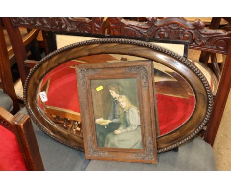 An oval bevel edged wall mirror in faux walnut frame and two prints 