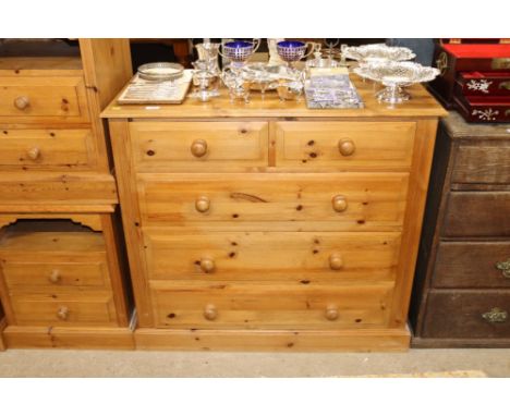 A modern stripped pine chest of two short and three long drawers 