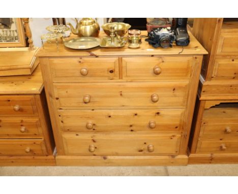 A modern stripped pine chest of two short and three long drawers 