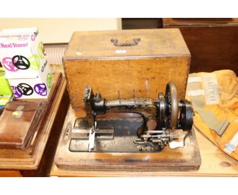 A vintage sewing machine in inlaid walnut case