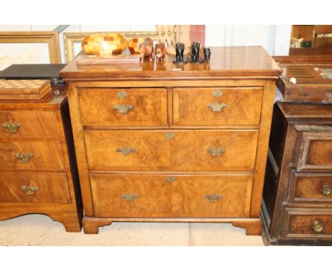 A 18th Century walnut and feather cross banded chest of two short and two long drawers on bracket feet