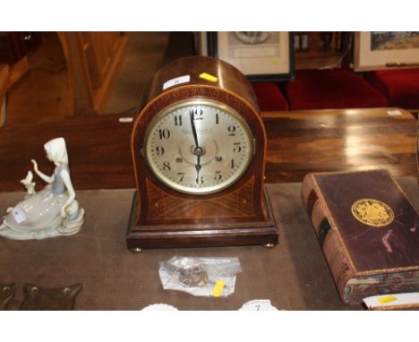 An Edwardian inlaid chiming mantel clock