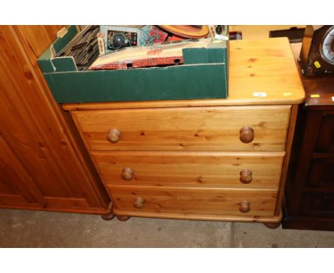 A modern pine chest of three drawers 