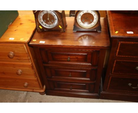 A mahogany bedside chest fitted three drawers 