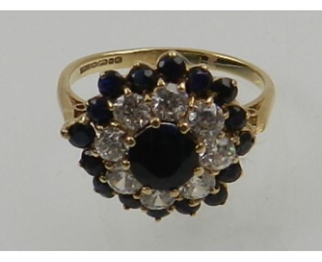 A 9 carat yellow gold, blue and white sapphire cluster ring. 
