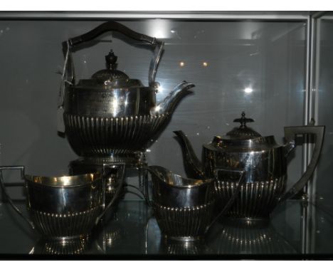 A Walker & Hall Victorian Sheffield silver plated three-piece tea service, having gadrooned design together with a matching p