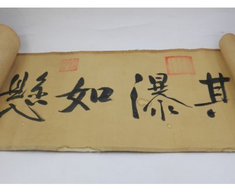 A Chinese scroll, decorated with figures in leisurely scenes and Chinese verse.