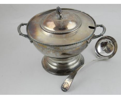 A silver plated tureen and cover, having scrolling handles, raised on circular base, with a silver plated ladle. H.22cm W.31c