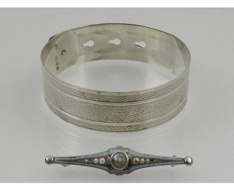 A Charles Horner silver 'belt' bangle, together with a Charles Horner bar brooch. (2)