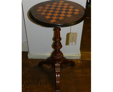 A 19th century mahogany circular games table, raised on a turned column support and tripod legs. H.75cm D.45cm