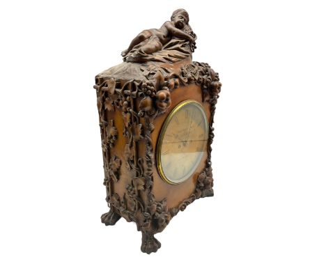 A  19th century carved walnut bracket clock and associated bracket,  case carved with representations of entwined vine leaves