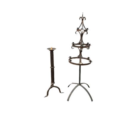 20th century scrolled wrought metal three tier candelabra, (H128cm) together with a wrought metal floor standing candle stick