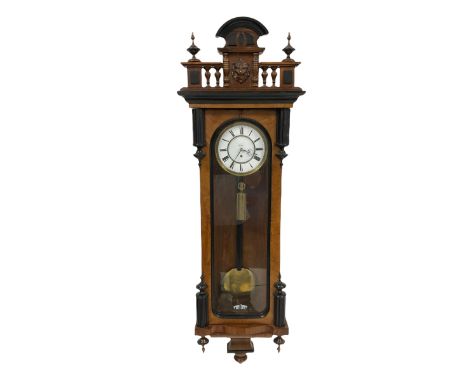 A late-nineteenth century eight-day Vienna Regulator with a 6" white enamel two-piece dial, Roman numerals and minute track, 